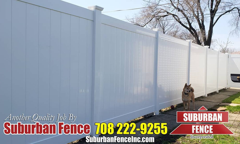 white vinyl fence enclosing the area with a dog in the photo