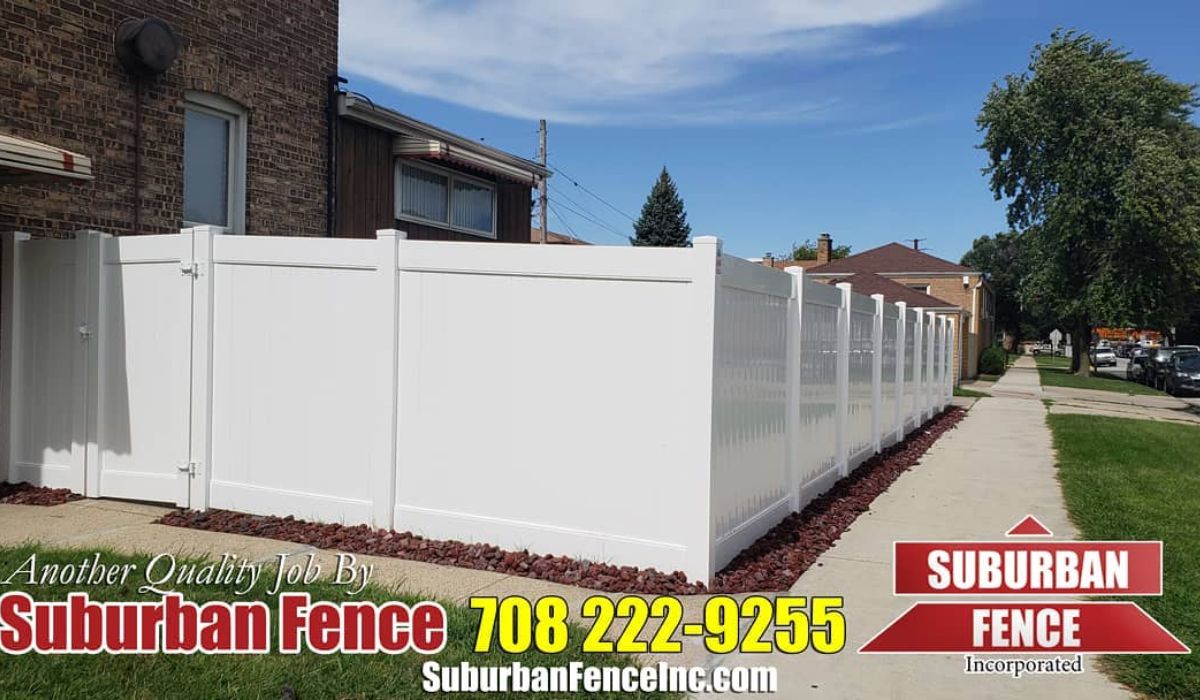 A substantial white vinyl fence enclosing the property
