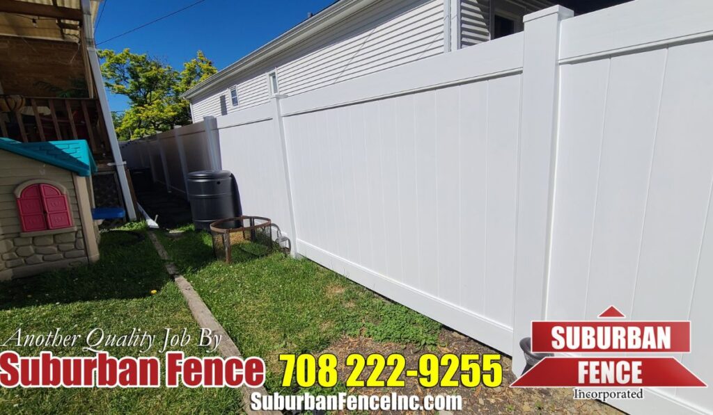 a white fence beside a dog house