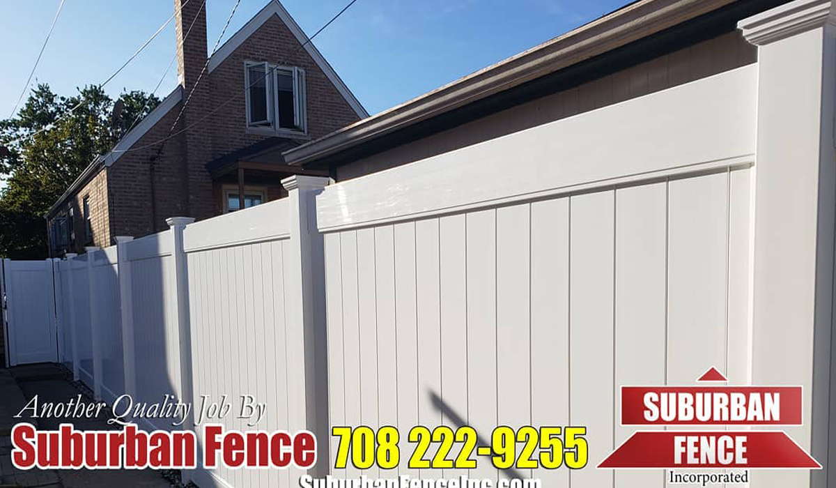 white vinyl fence installed in a backyard