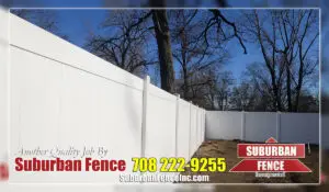 White vinyl fence in backyard.
