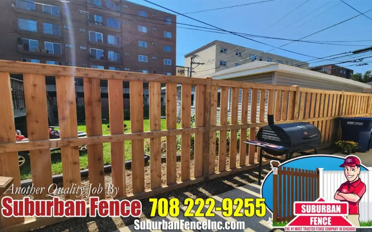 Shadowbox wood fence installation showcasing backyard privacy options – Wood fence installation cost calculator included.