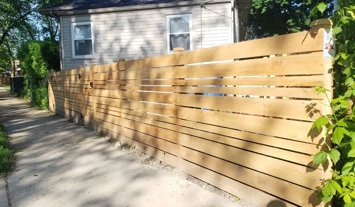 Horizontal wood fencing featured on a Chicago home as one of 2025’s popular fence styles.