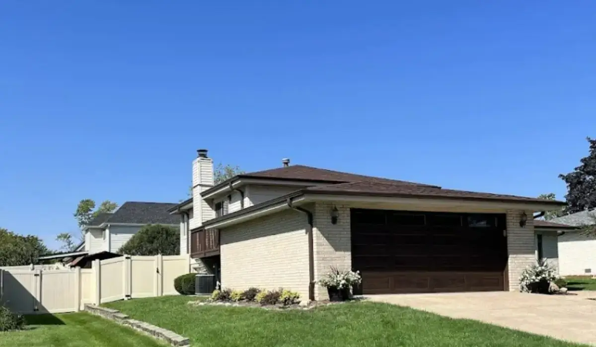 Chicago suburban home with new vinyl fence and well-kept front yard boosting resale value.