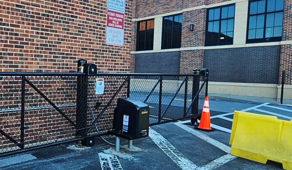 Automated black warehouse fencing gate with reinforced access barriers, enhancing security at a Chicago commercial property.